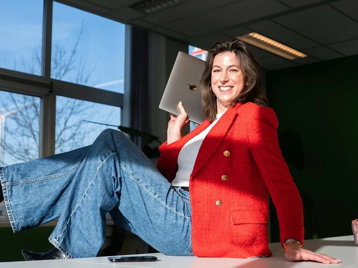 Amber, Creative at Pro Contact, with her laptop on a desk in the office