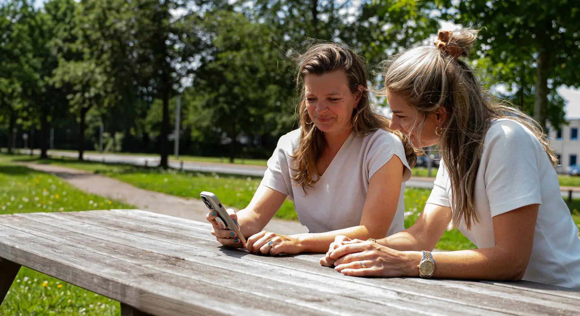 Yanouk and Carlijn from Pro Contact outside at the picnic table