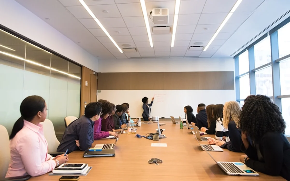 Team seated around a long boardroom table during a presentation
