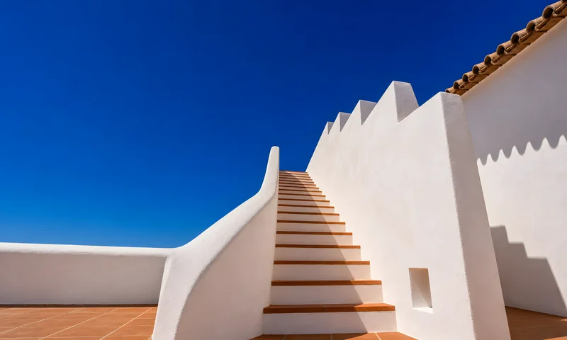 Whitewashed stairs against a deep blue sky