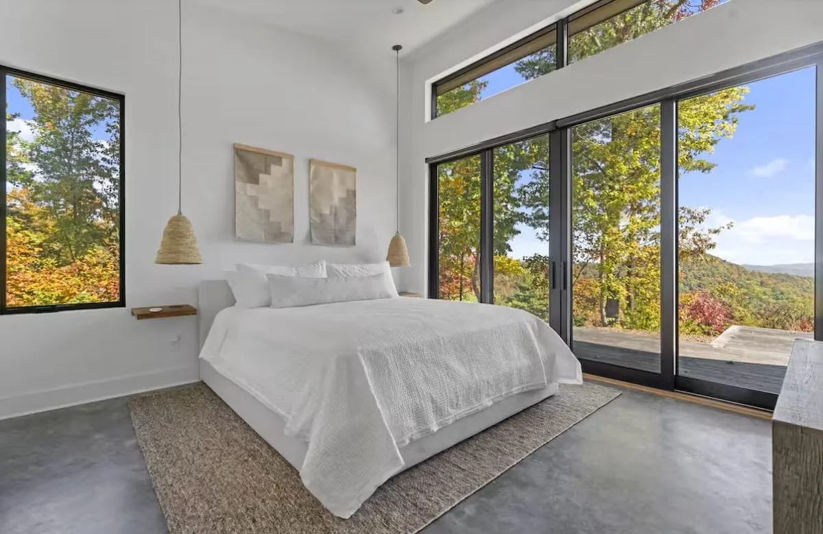 King suite at Lost Ridge with sliding glass doors opening onto the deck and the ridgeline beyond