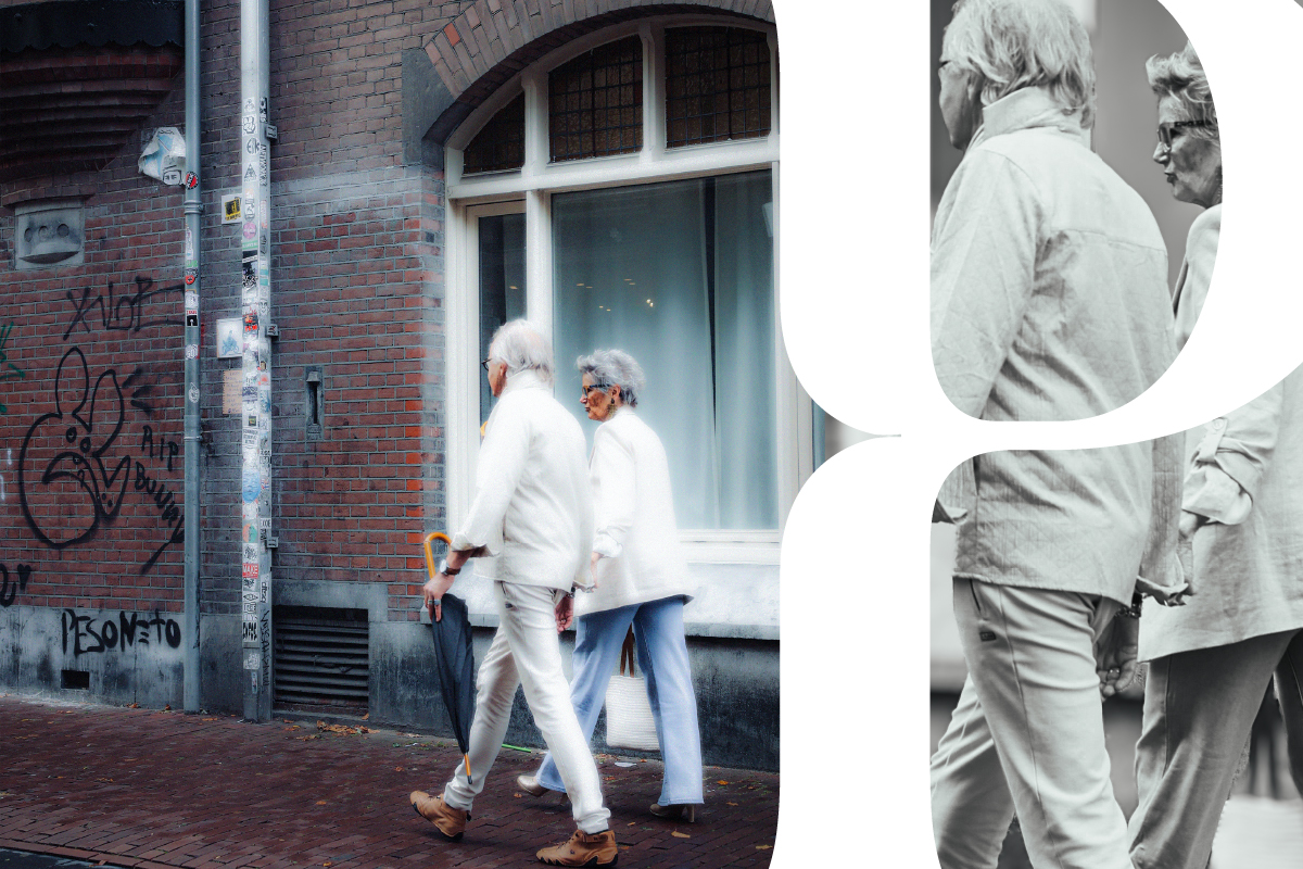 Older couple walking hand in hand on a coastal path