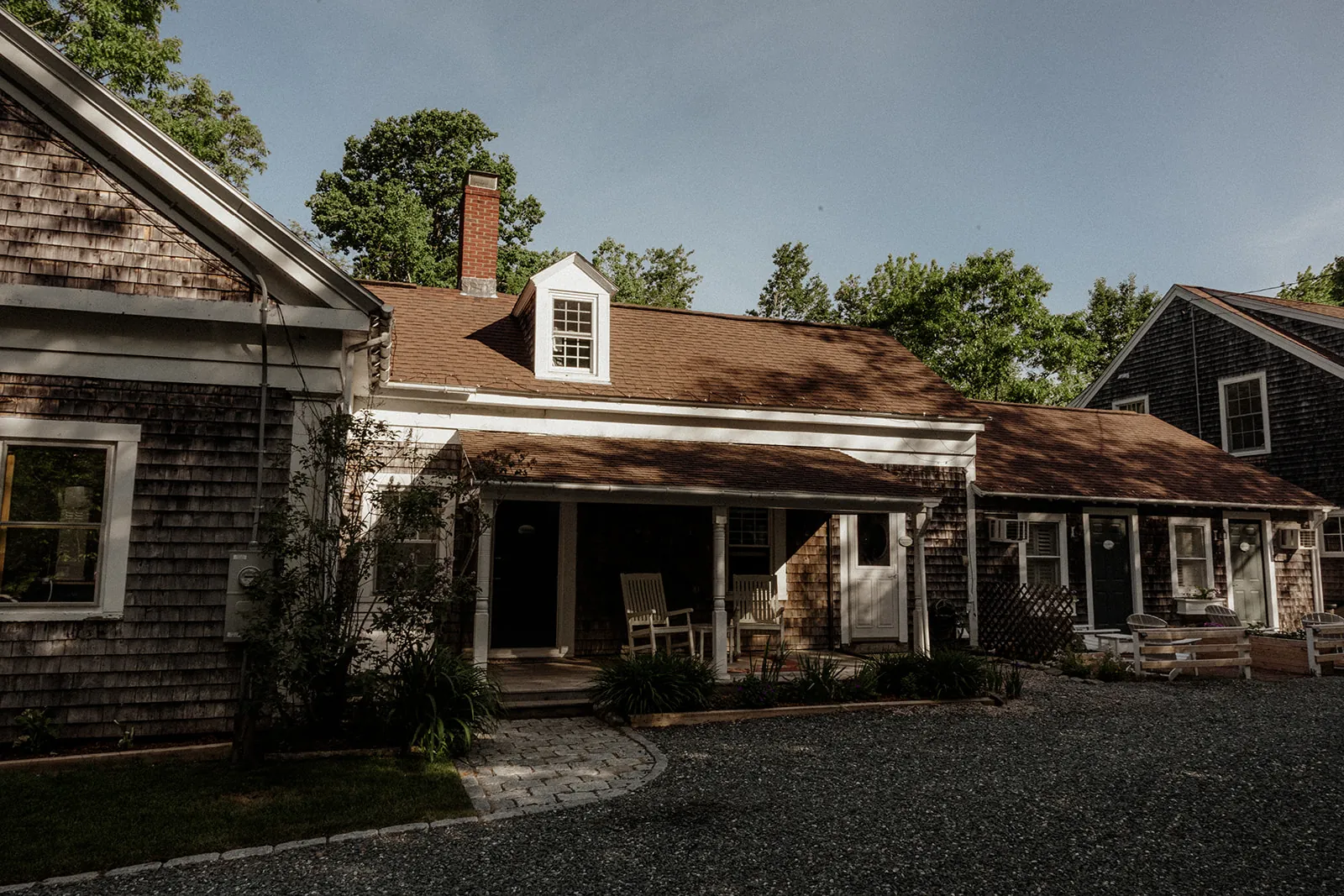 Private guest room entrances surrounded by gardens at Coach Stop Inn