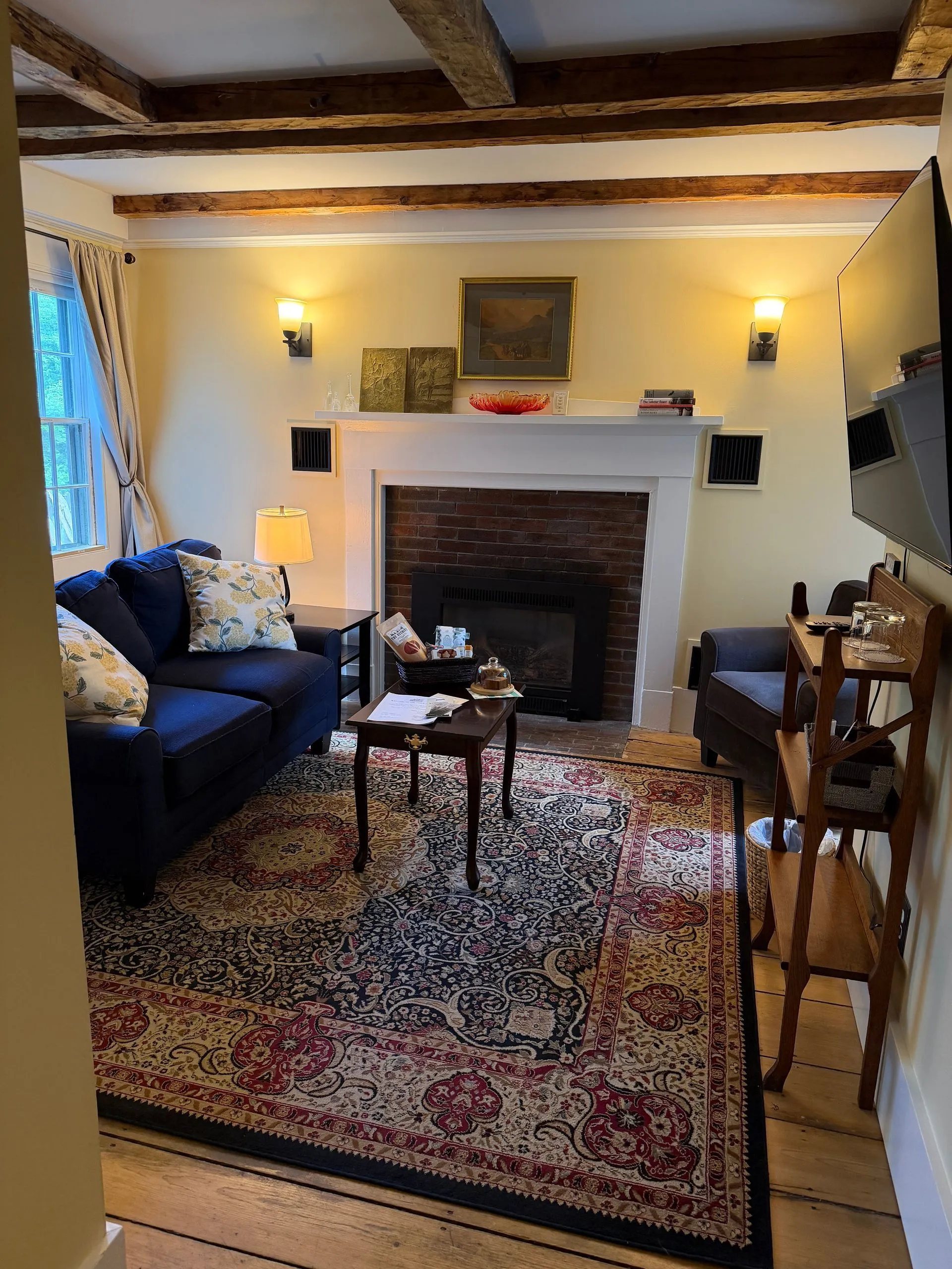Living room with gas fireplace in the Tavern suite at Coach Stop Inn