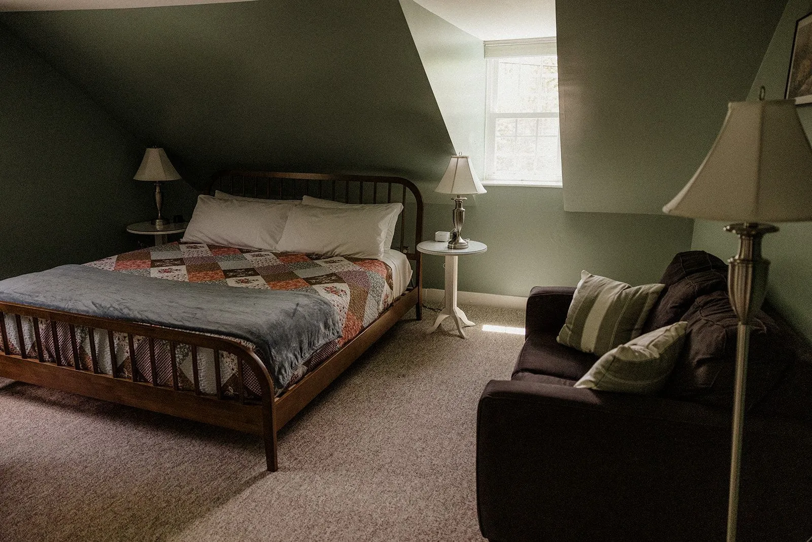King bed and seating area in the Acadia room at Coach Stop Inn