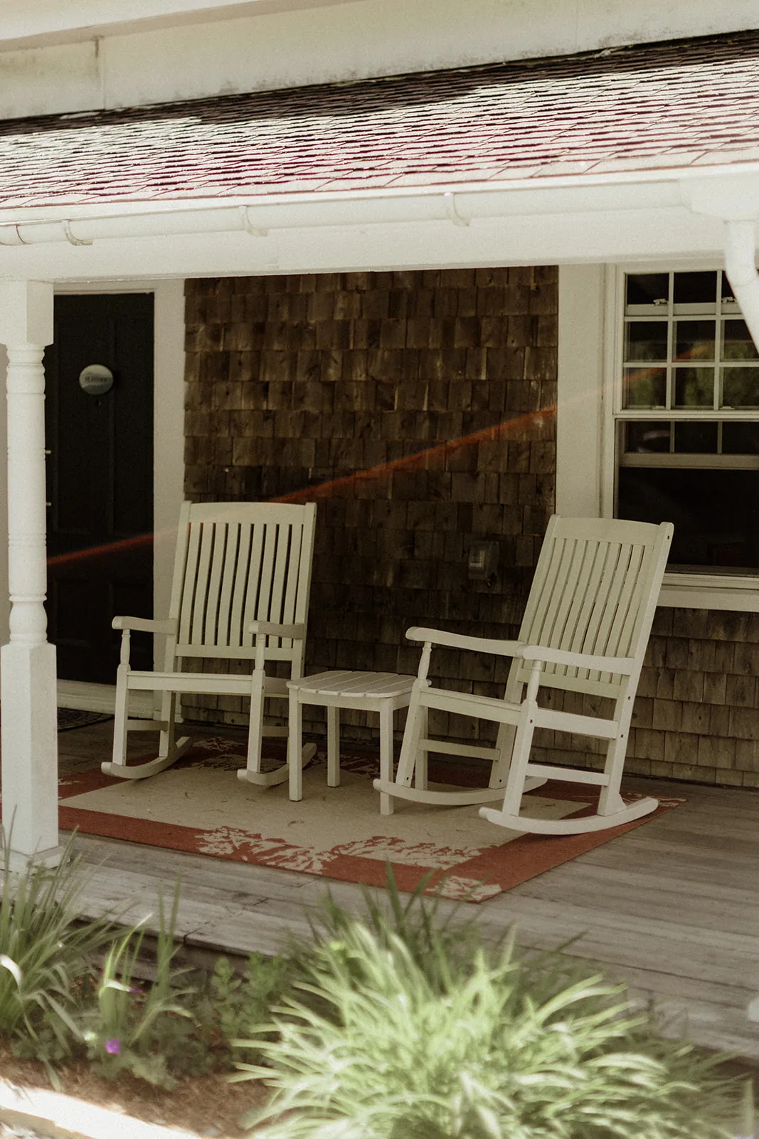Covered porch and private outdoor seating for the Heritage room at Coach Stop Inn