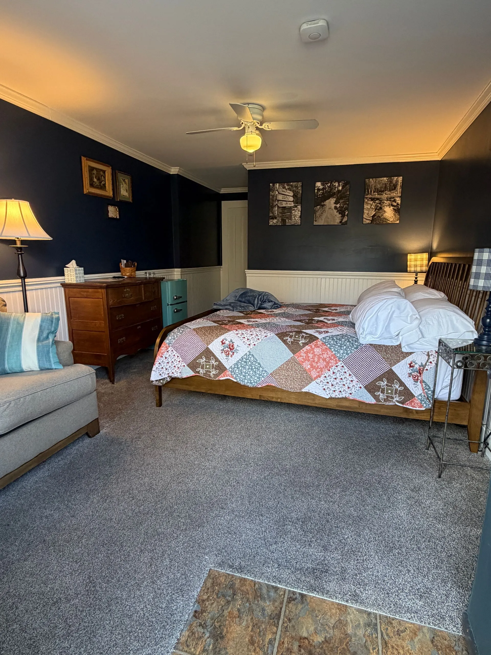 King bed and loveseat in the Blue Hill Bay room at Coach Stop Inn