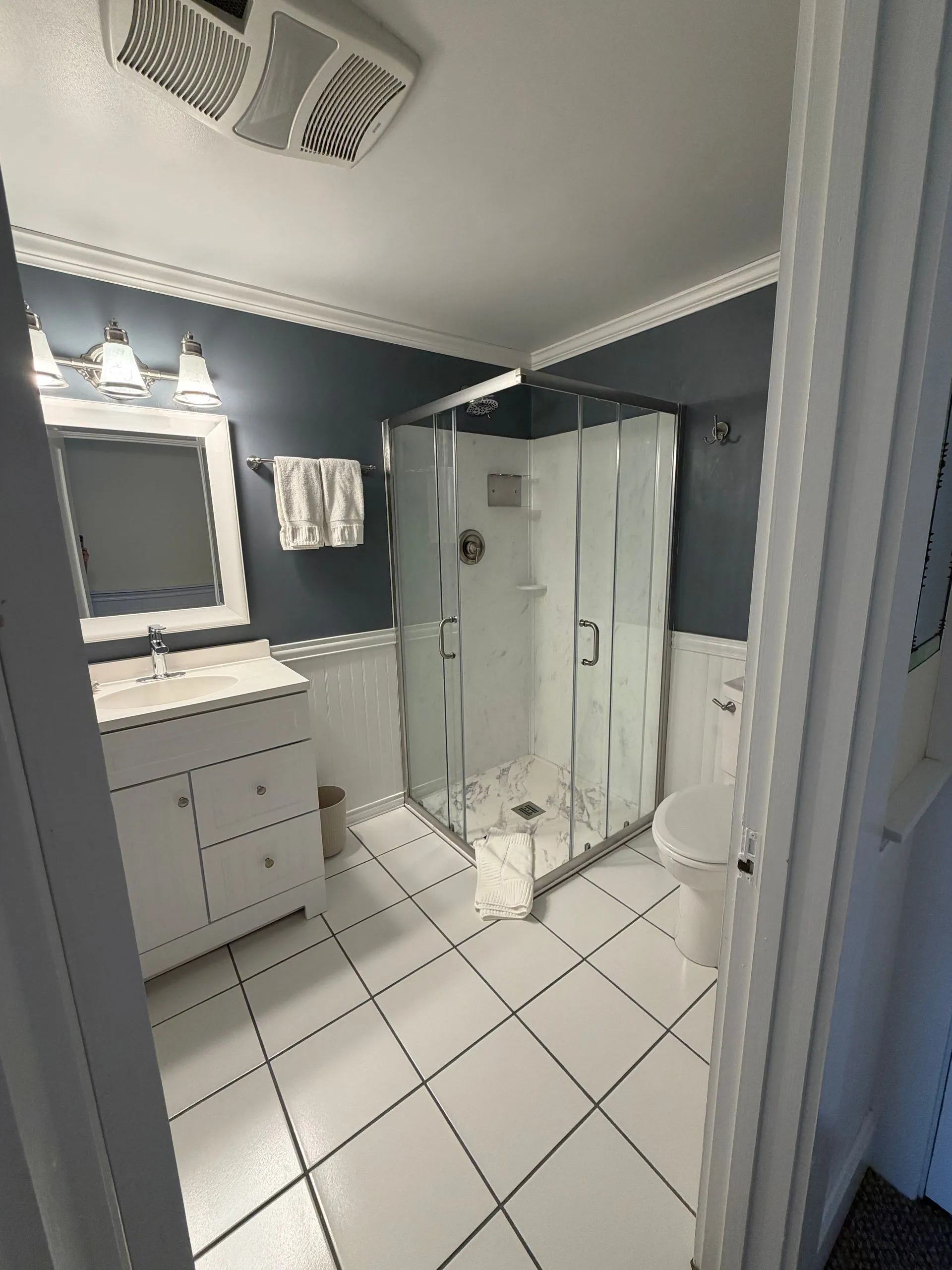 Private bathroom with walk-in shower in the Somes Sound room at Coach Stop Inn
