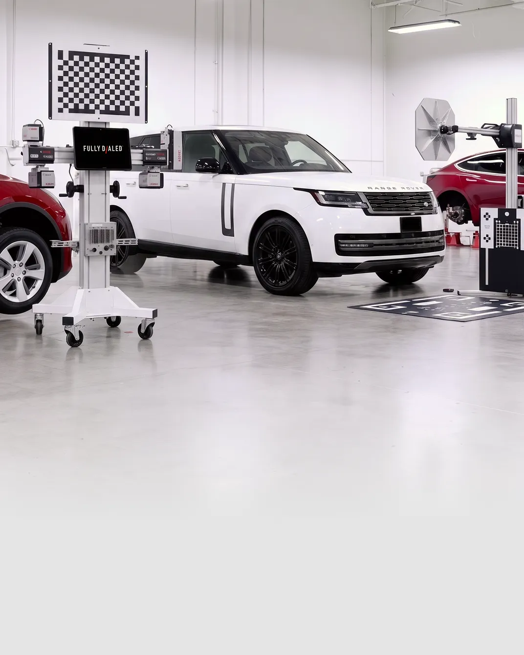 Fully Dialed calibration bay with a white Range Rover in front of the ADAS rig