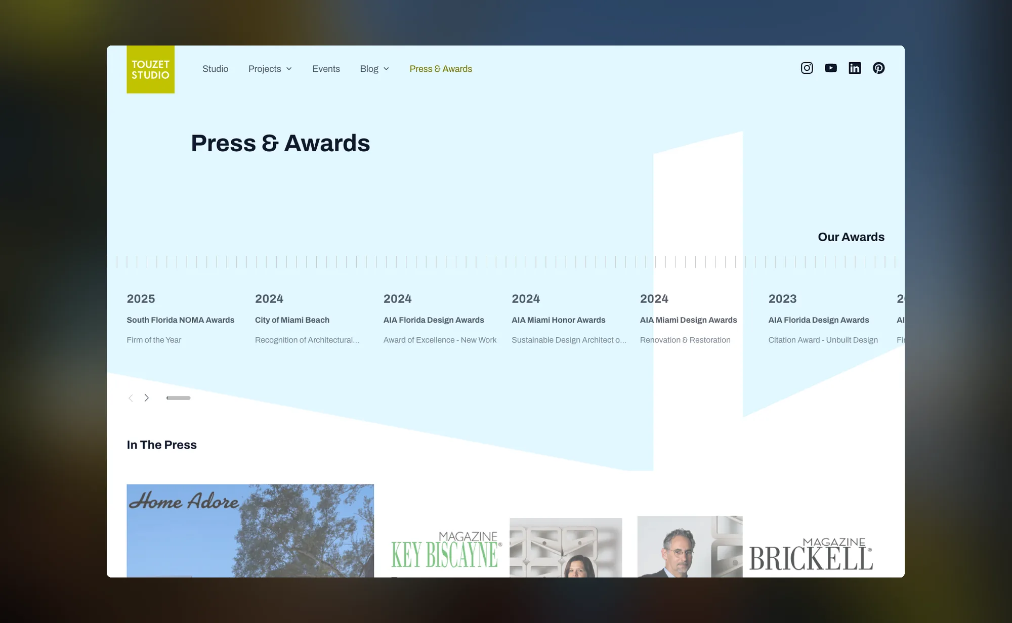The press and awards page, with an awards timeline running by year above a row of press logos
