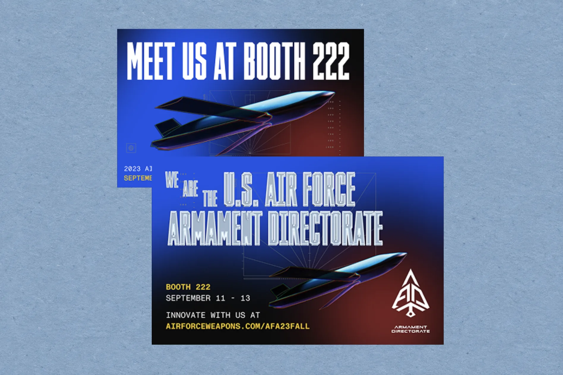 Two Air Force Armament Directorate event cards reading Meet us at booth 222 with aircraft artwork, on air-force blue paper