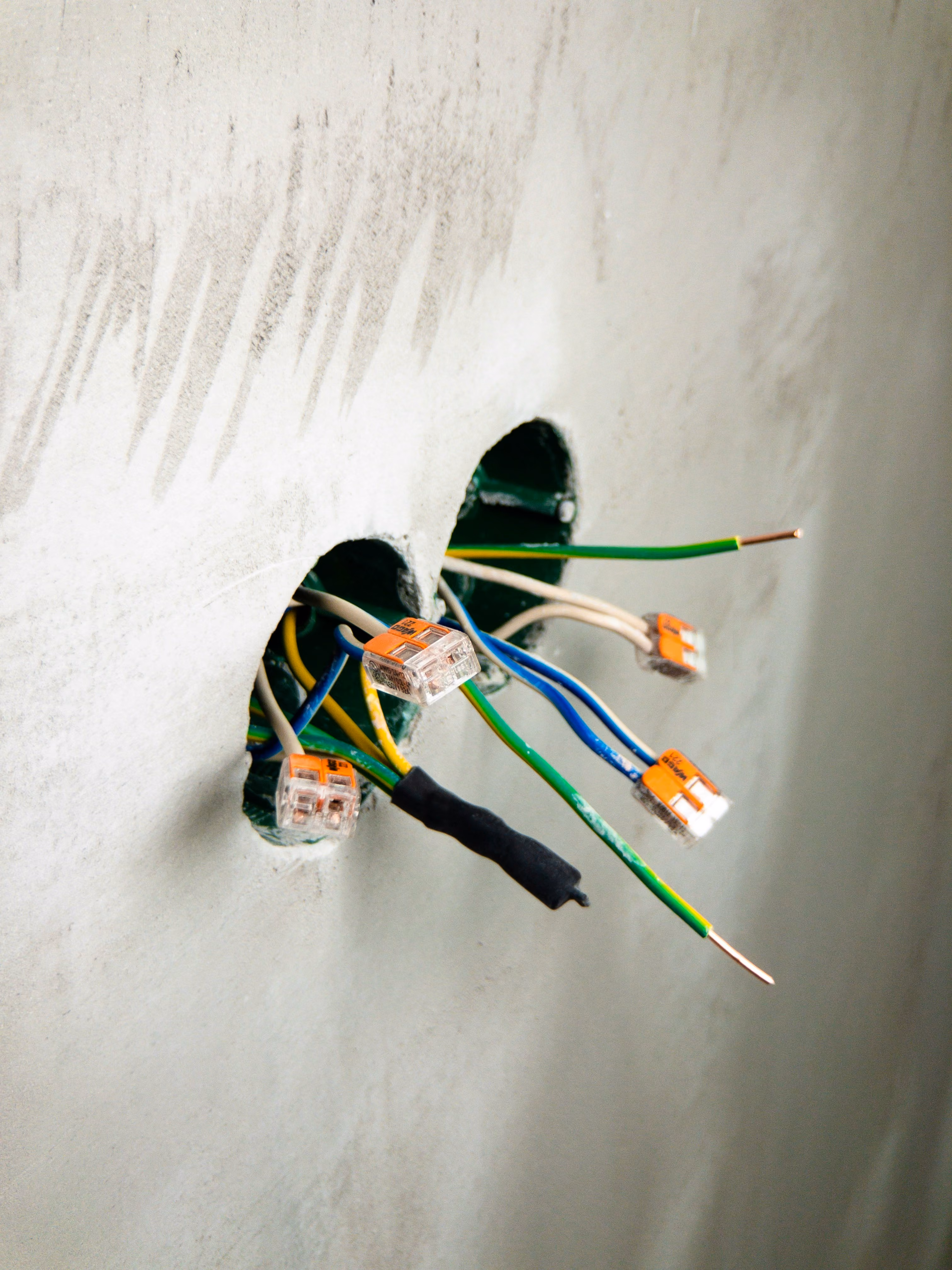 Low-voltage wiring being installed inside a residential wall