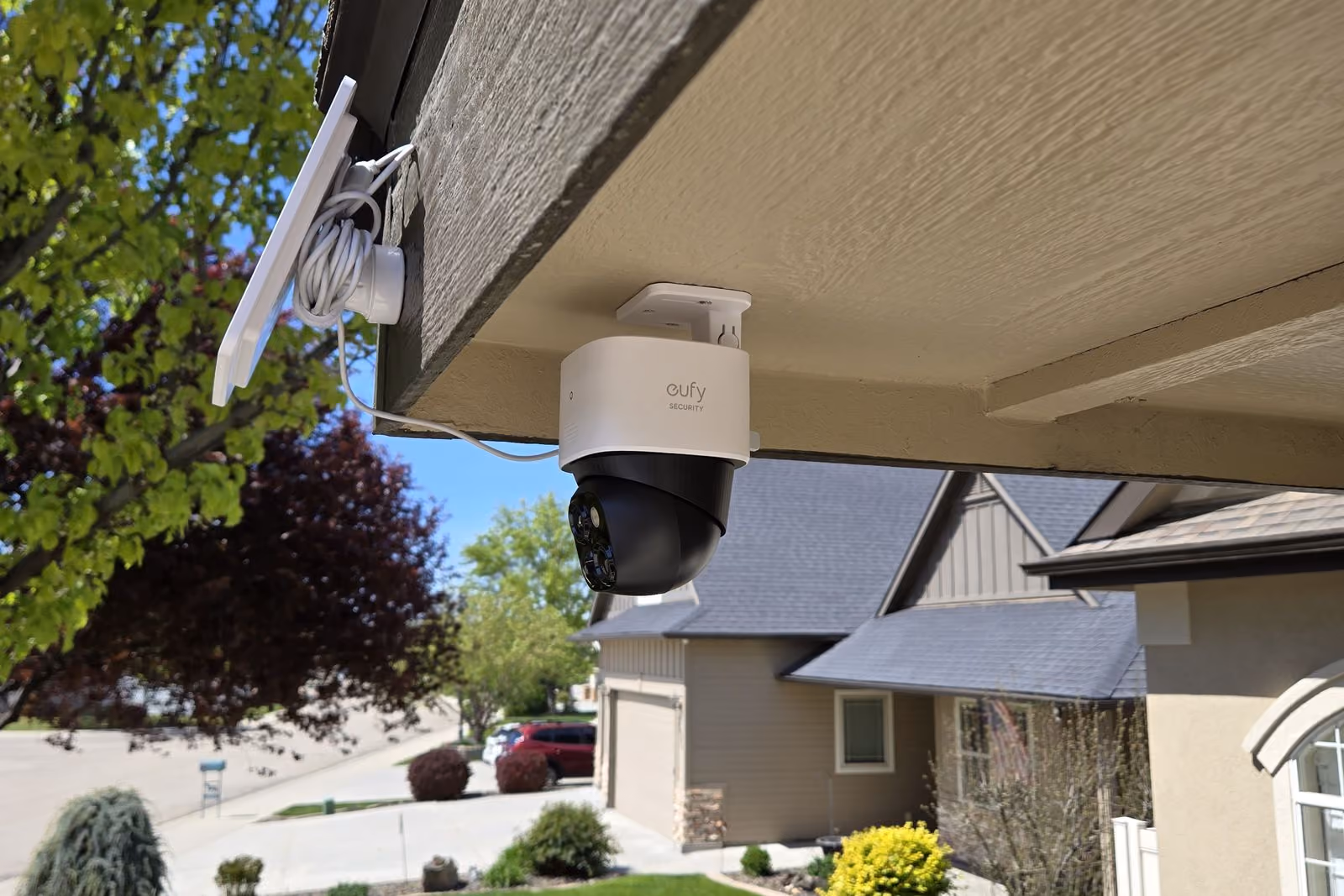 Eufy outdoor security camera installed under a home's roofline