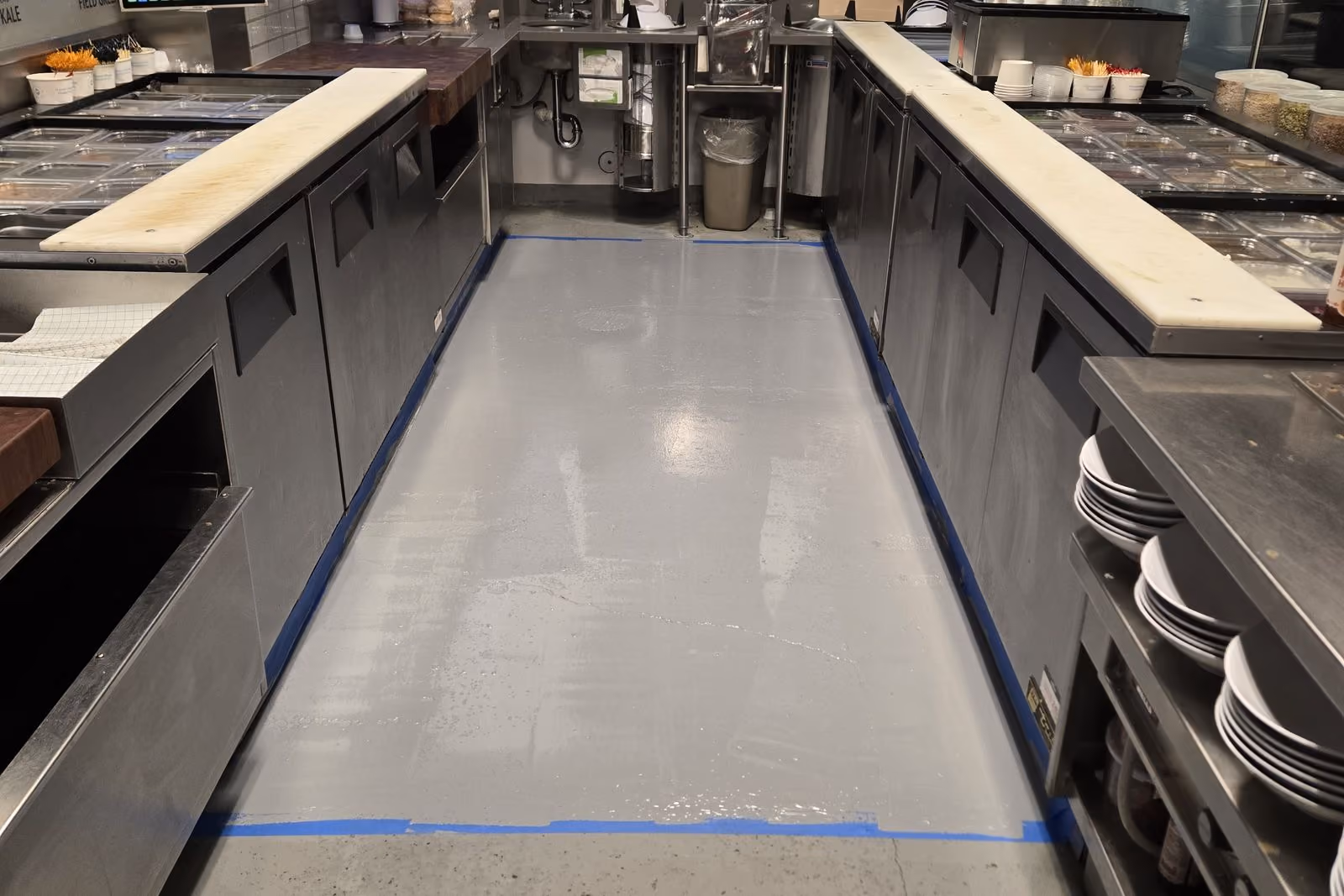 Commercial kitchen floor after: clean gray coated surface