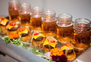 Mini cheeseburger sliders paired with mason jars of beer