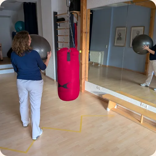 Übung mit einem Gymnastikball im Bewegungsraum