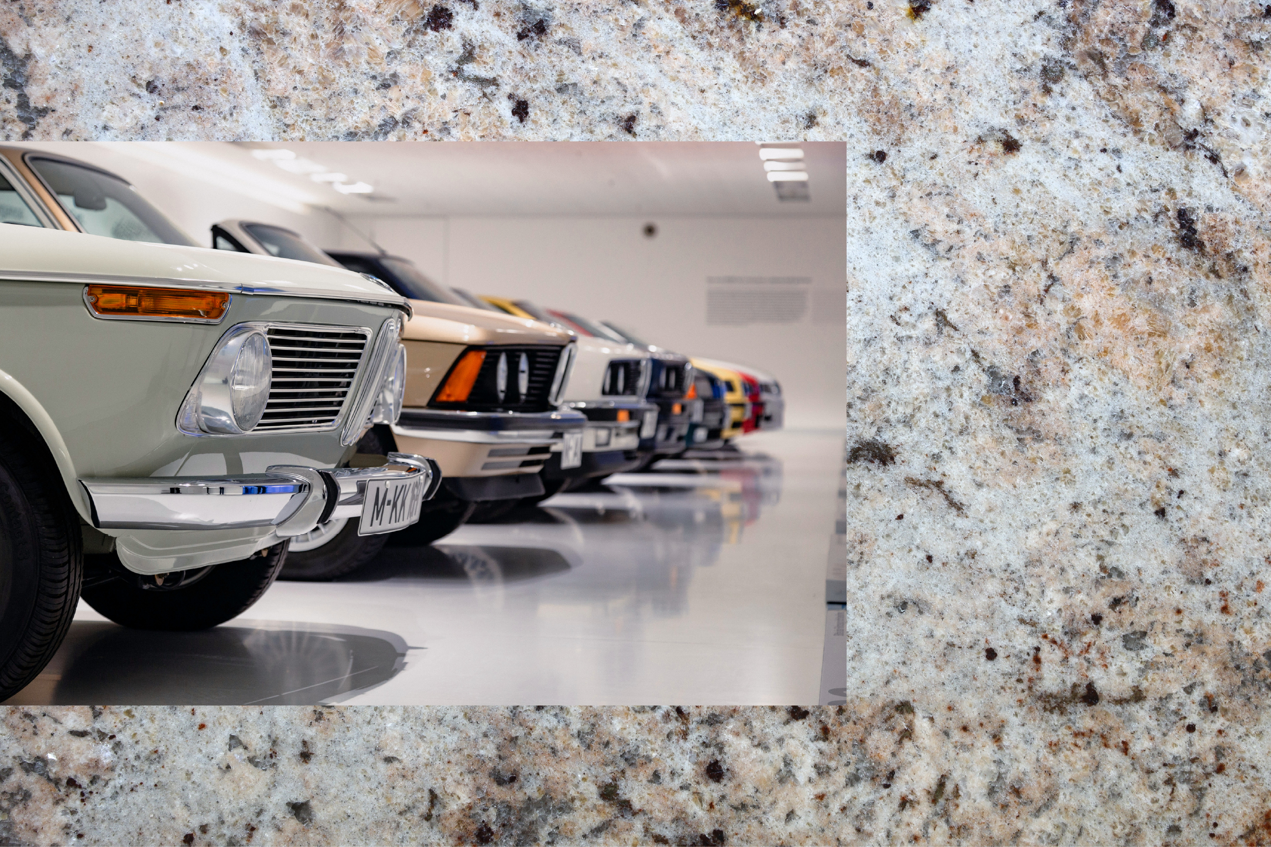 A row of classic automobiles in a private showroom