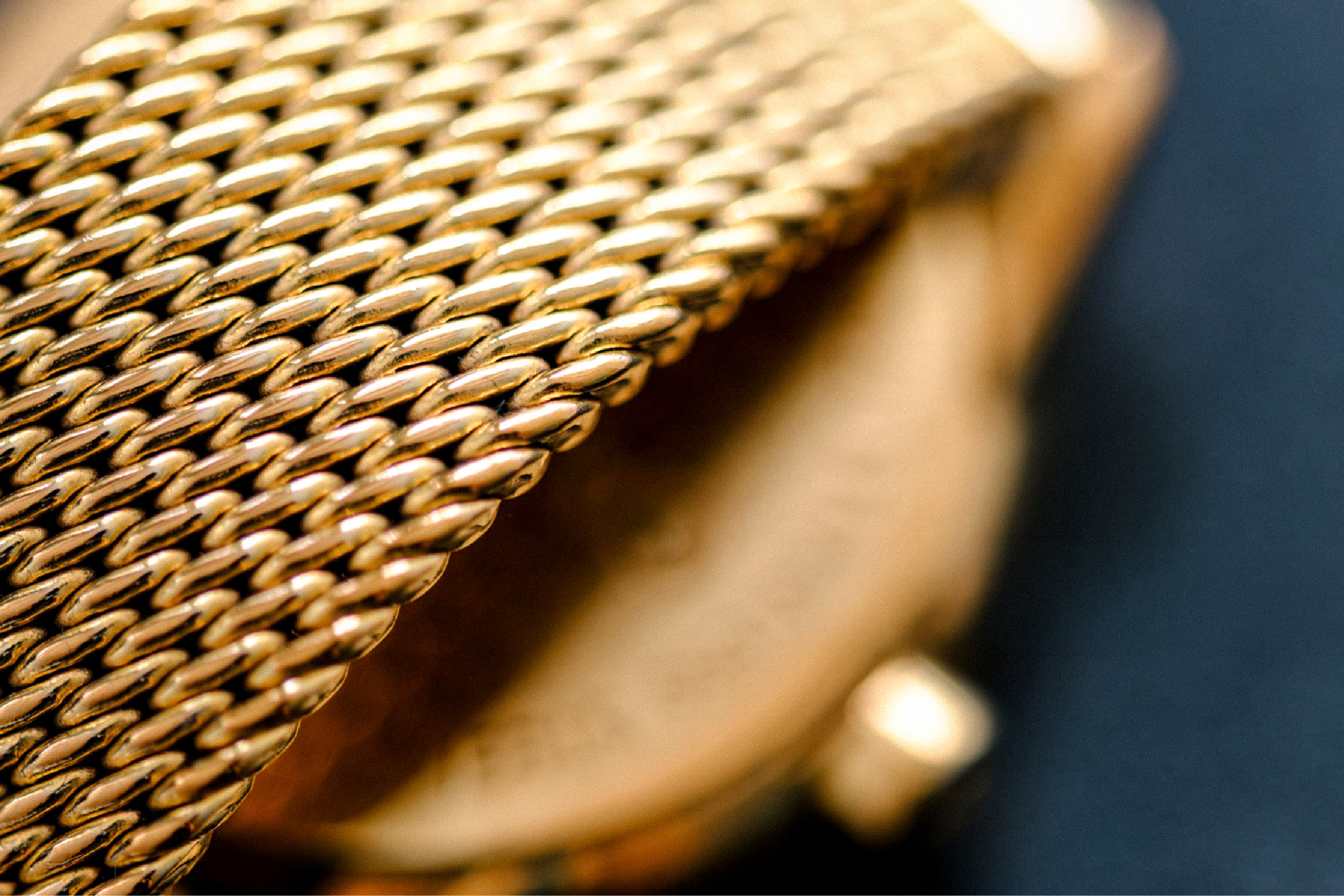 A gold bracelet watch photographed close