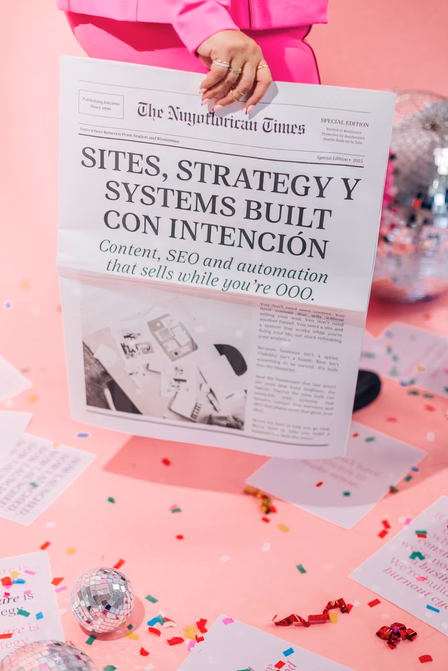 Kristine Gonzalez holding a newspaper with the headline Sites, Strategy y Systems Built con Intención