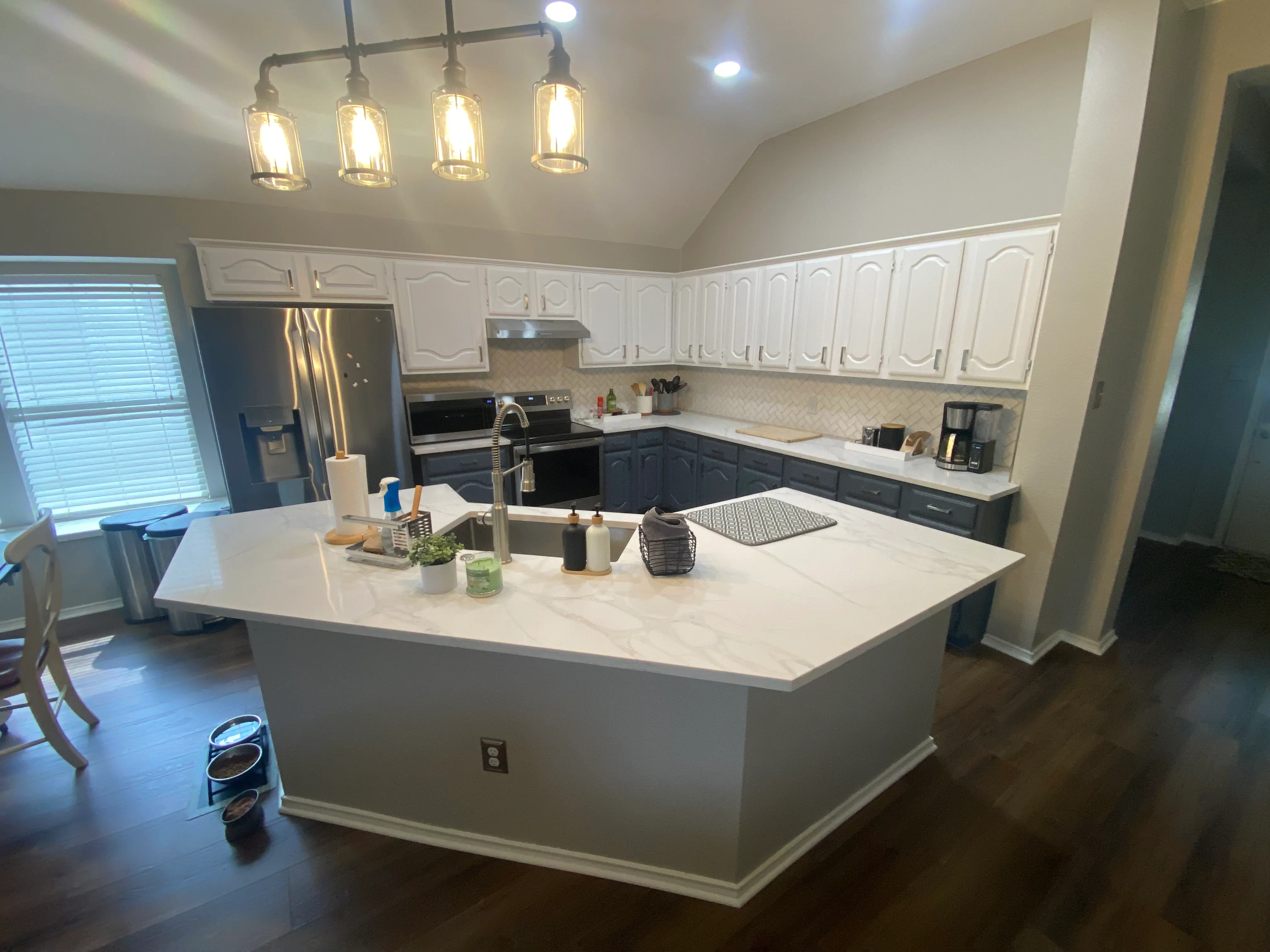 Lewisville kitchen remodel with herringbone backsplash, quartz countertops and two-tone cabinets by Redcrest Construction