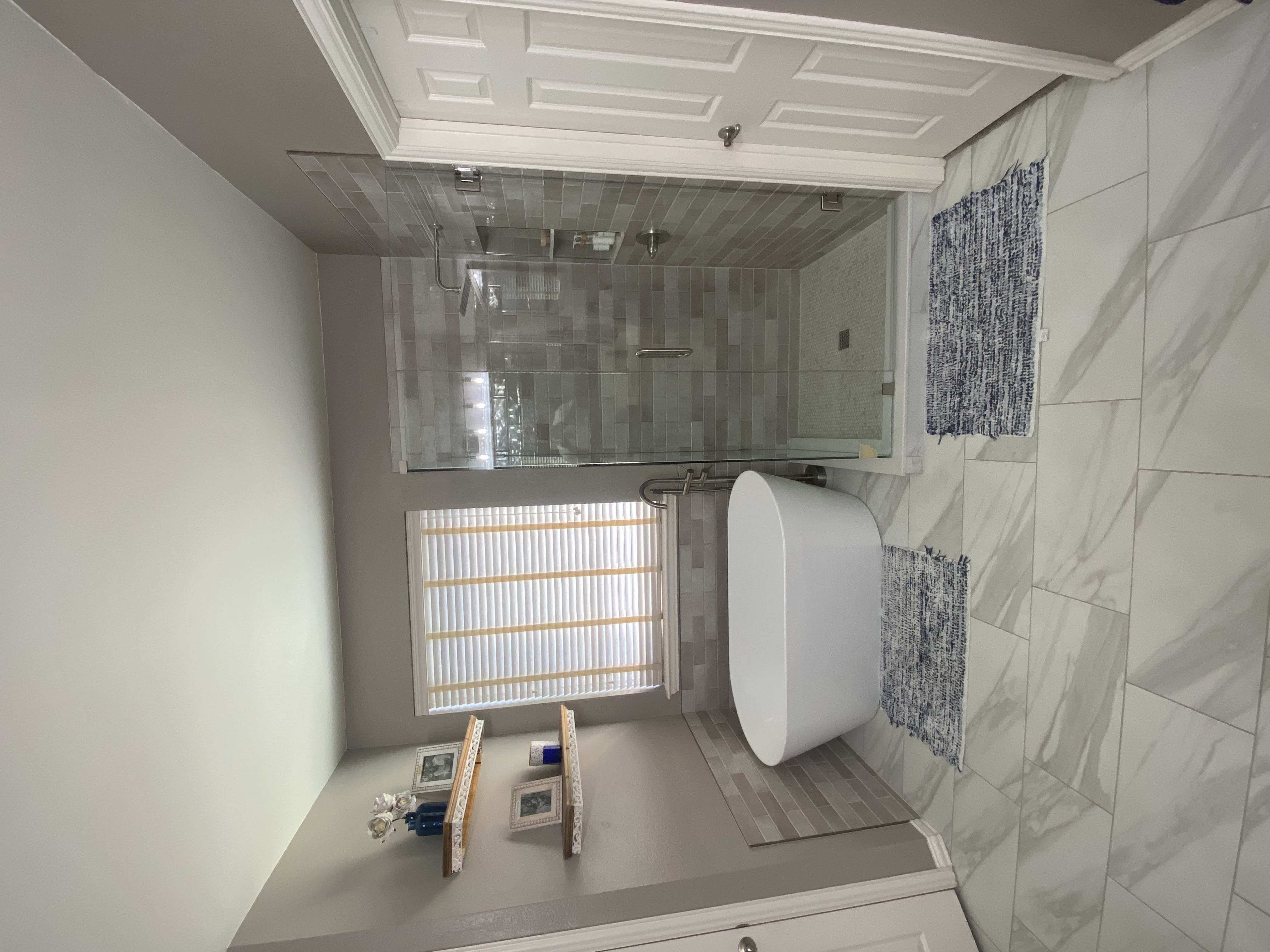 Completed Fort Worth master bathroom remodel with enlarged walk-in shower and freestanding tub by Redcrest Construction