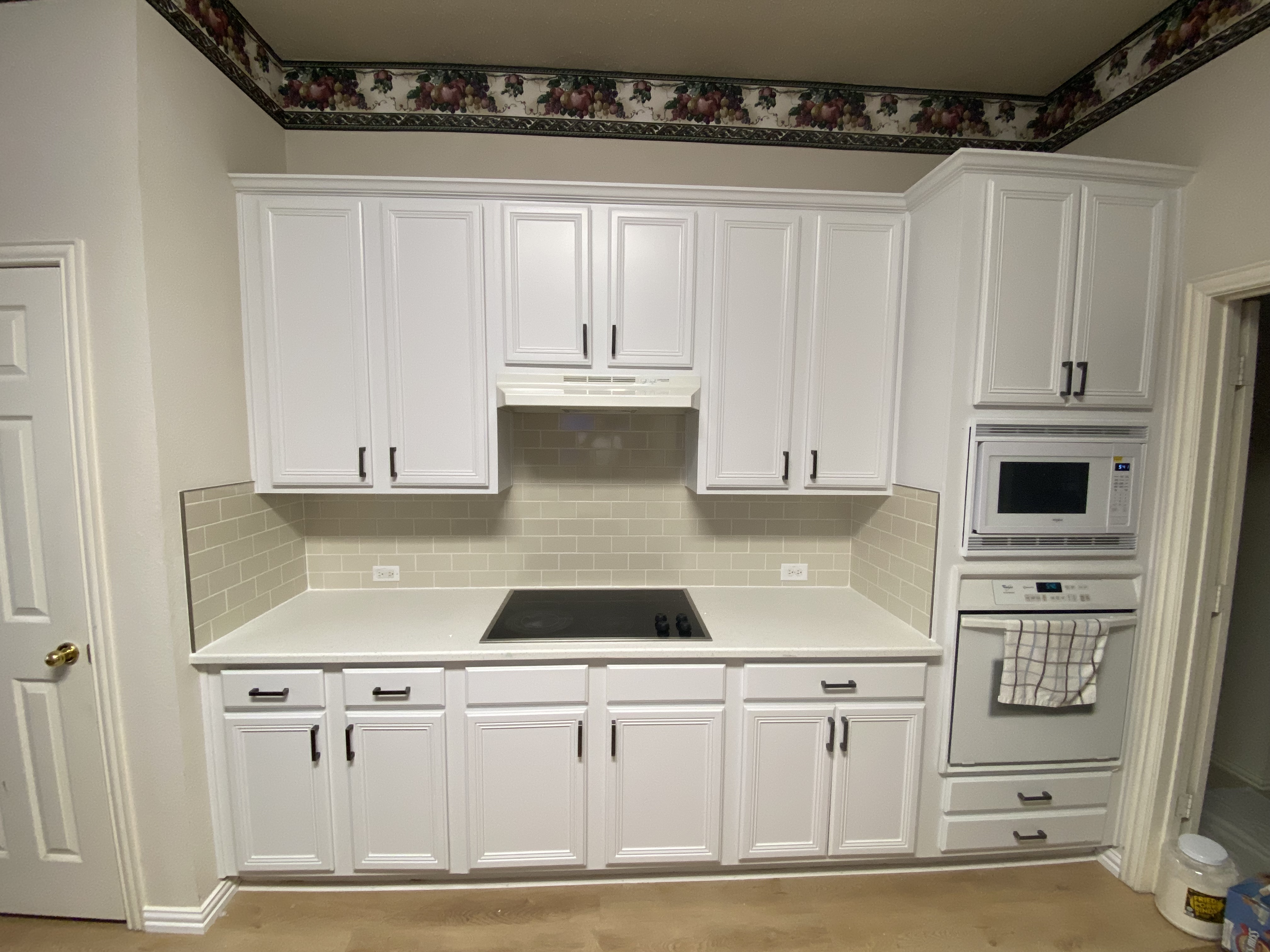 Flower Mound kitchen restored with rebuilt base cabinets, white painted cabinets, quartz countertops and off-white tile backsplash