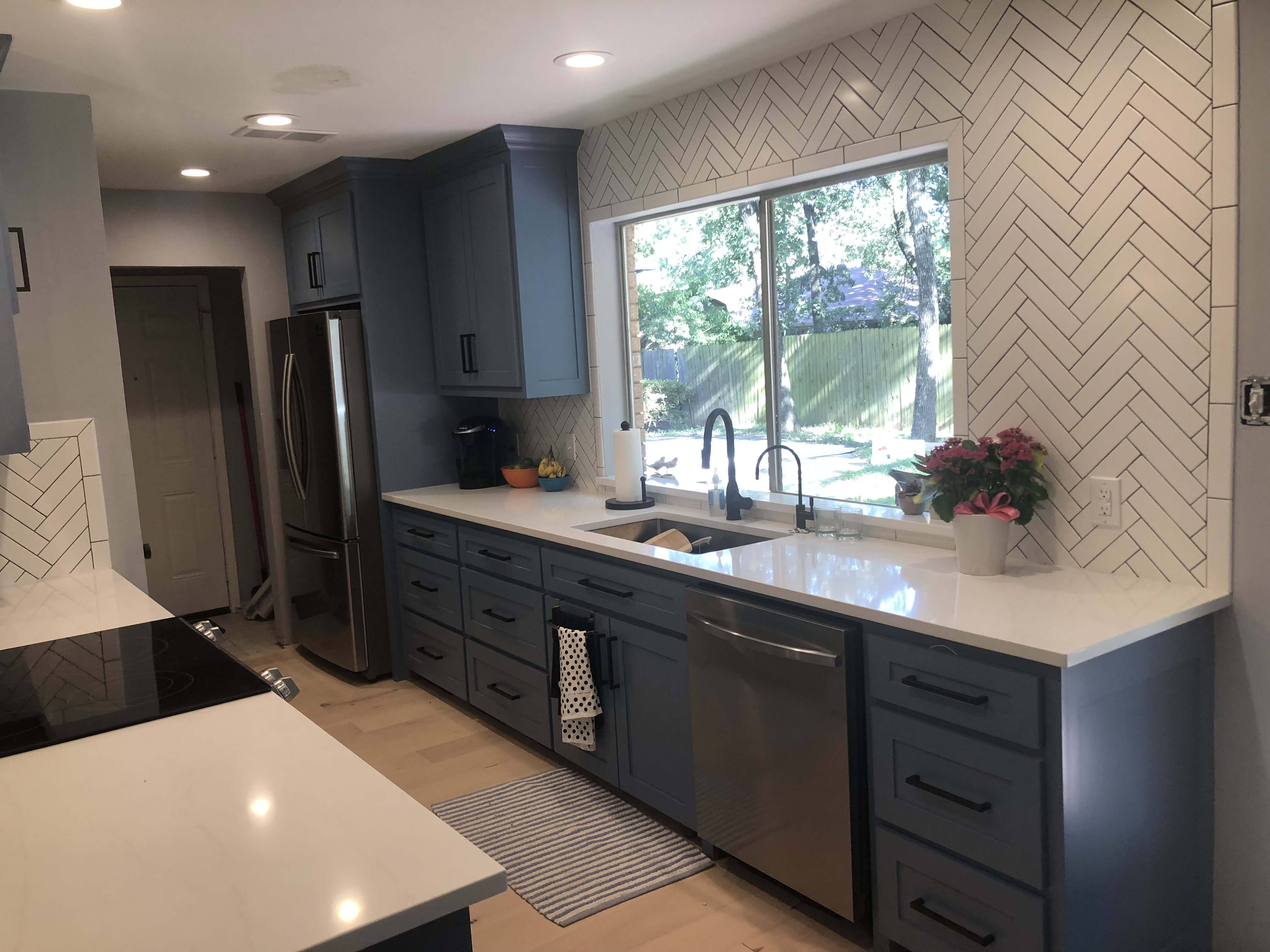 Coppell kitchen remodel with blue shaker cabinets, quartz countertops and full-height white tile backsplash
