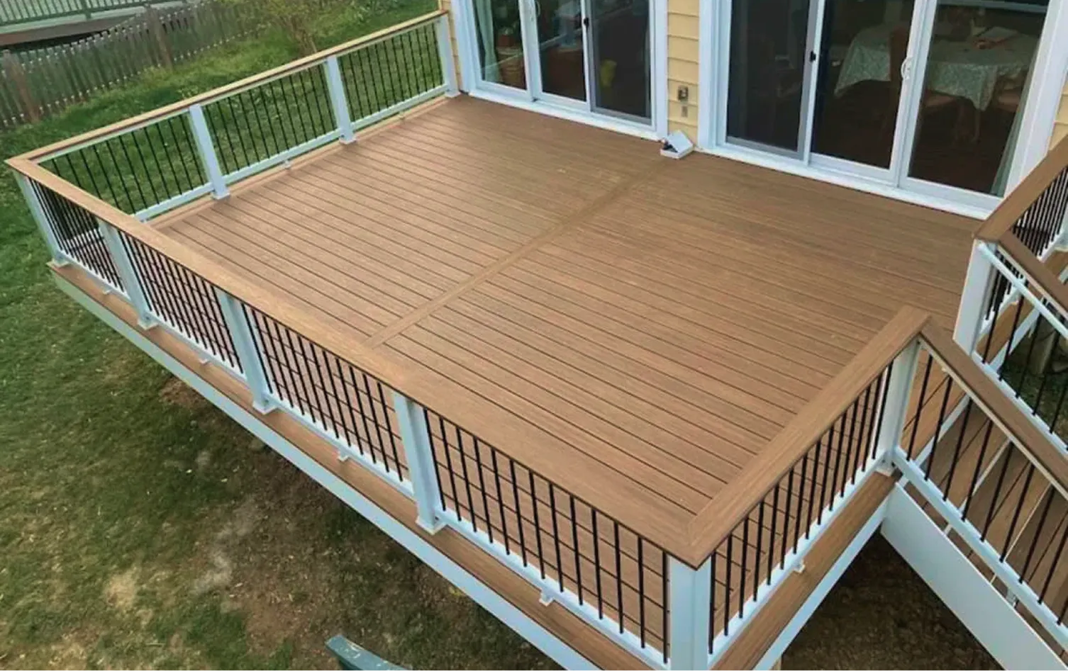New deck construction with composite decking and modern railings
