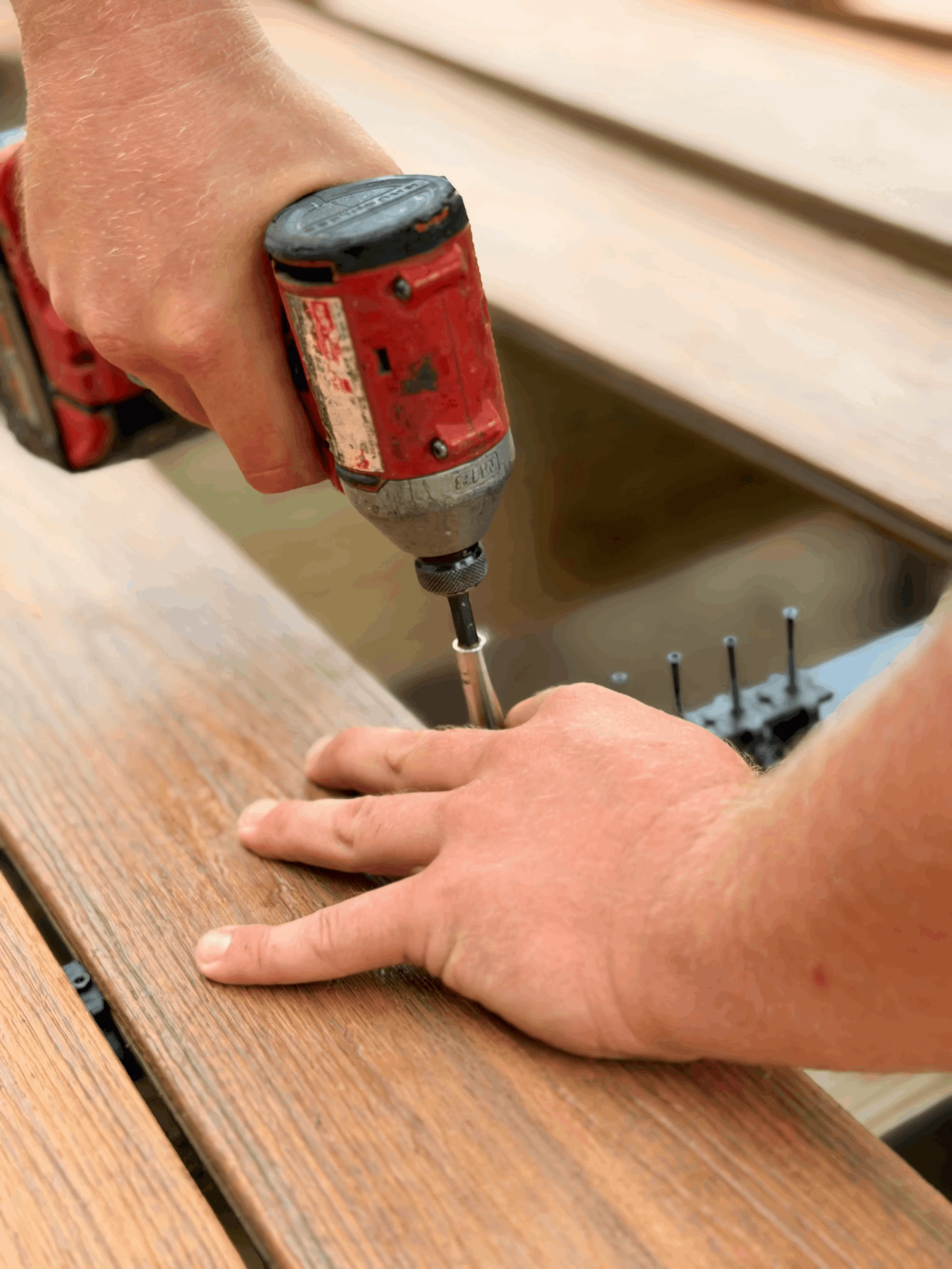 Installing composite deck boards with hidden fasteners and an impact driver