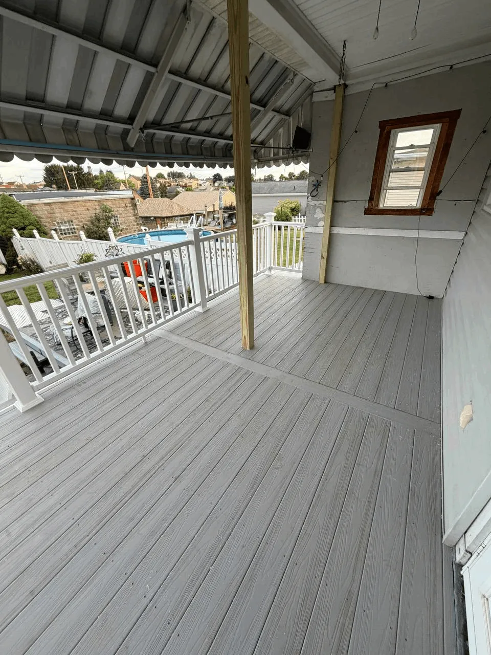 New deck built from the ground up with gray decking and white railings.