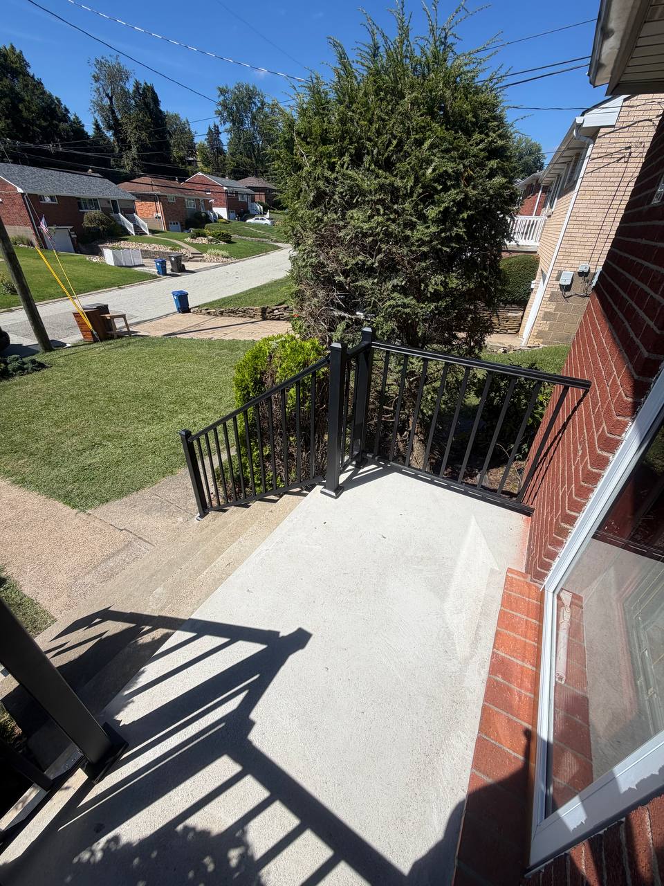 New deck built from the ground up with gray decking and white railings.
