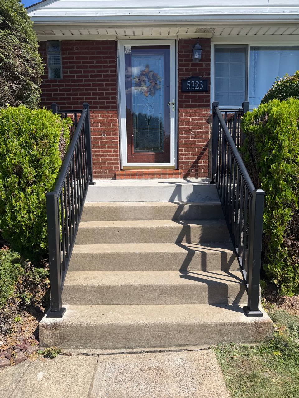 New deck built from the ground up with gray decking and white railings.