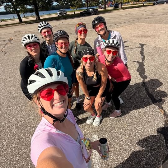 Group selfie of Girlie Biker Gang riders in helmets and pink sunglasses