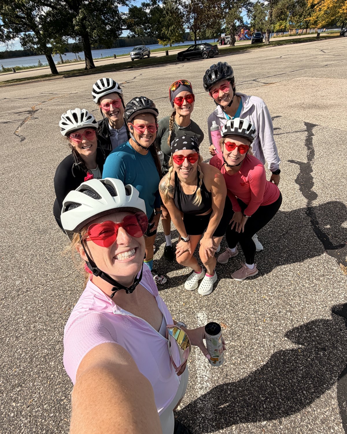 Sydney taking a selfie with smiling Girlie Biker Gang riders in helmets and pink heart sunglasses