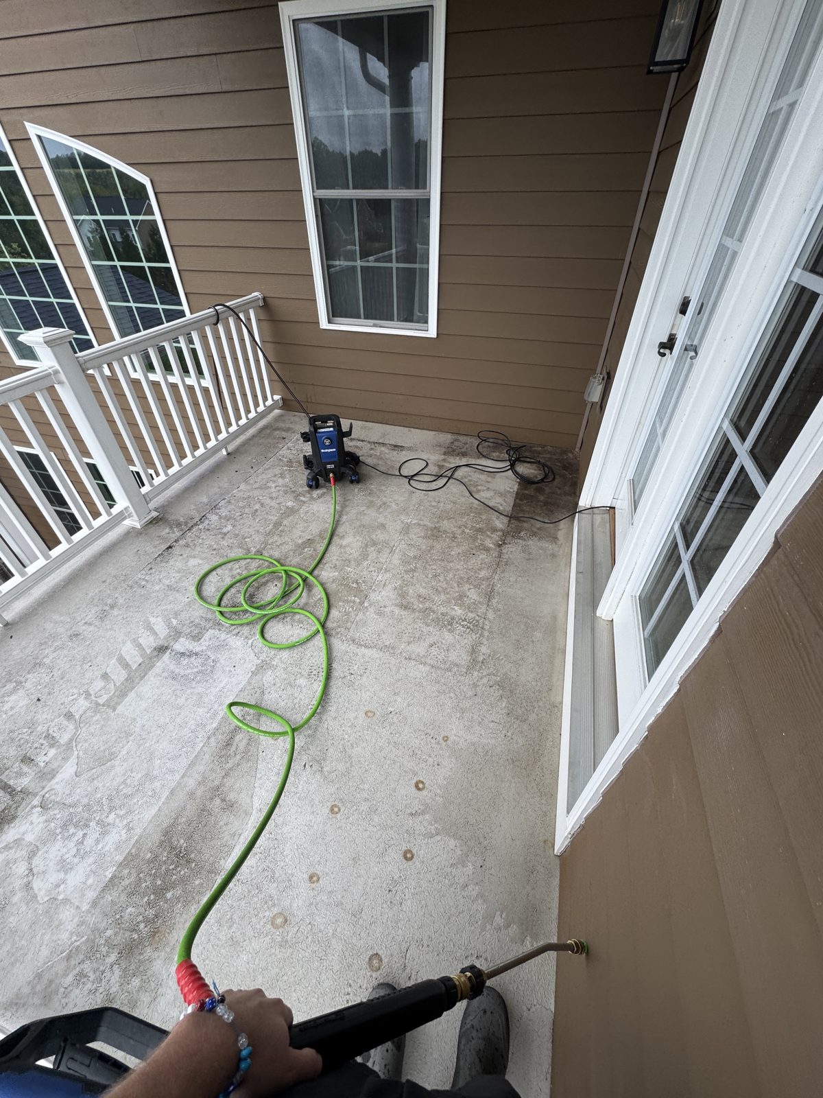 Pressure washer working on a deck