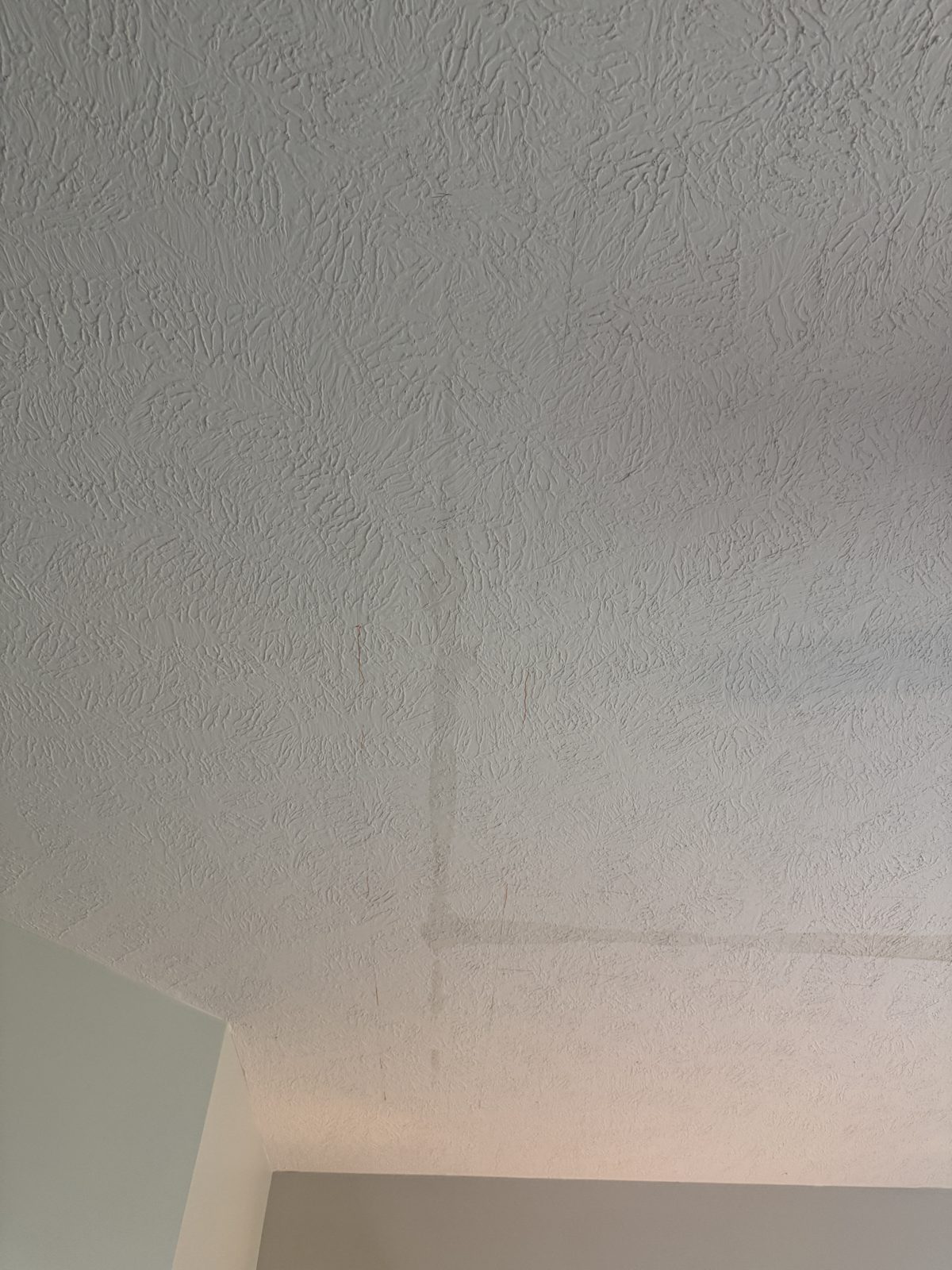 The same ceiling repaired, textured and painted