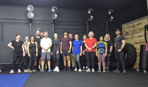 Members after a group coaching session mixing weights and cardio inside our gym