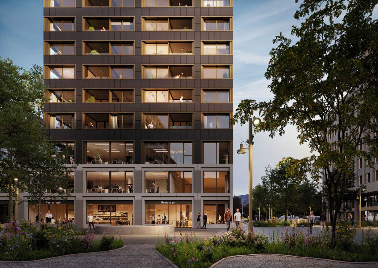 Modern multi-story building with large windows, a restaurant on the ground floor, and people walking outside in a landscaped urban area during evening.