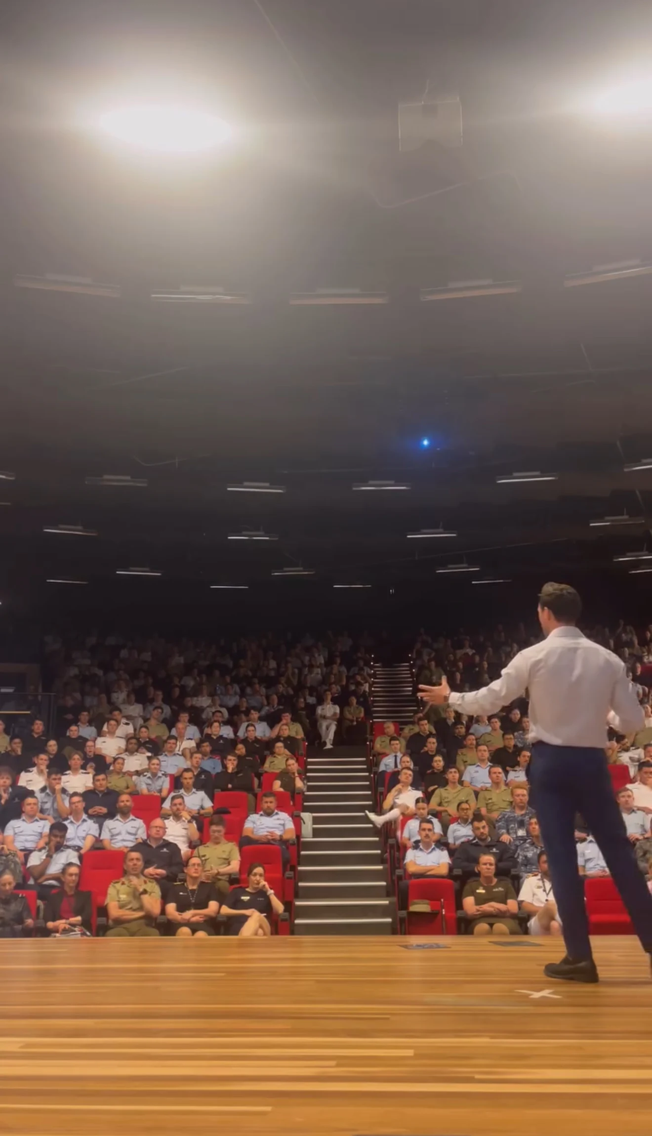 Benjamin speaking on stage