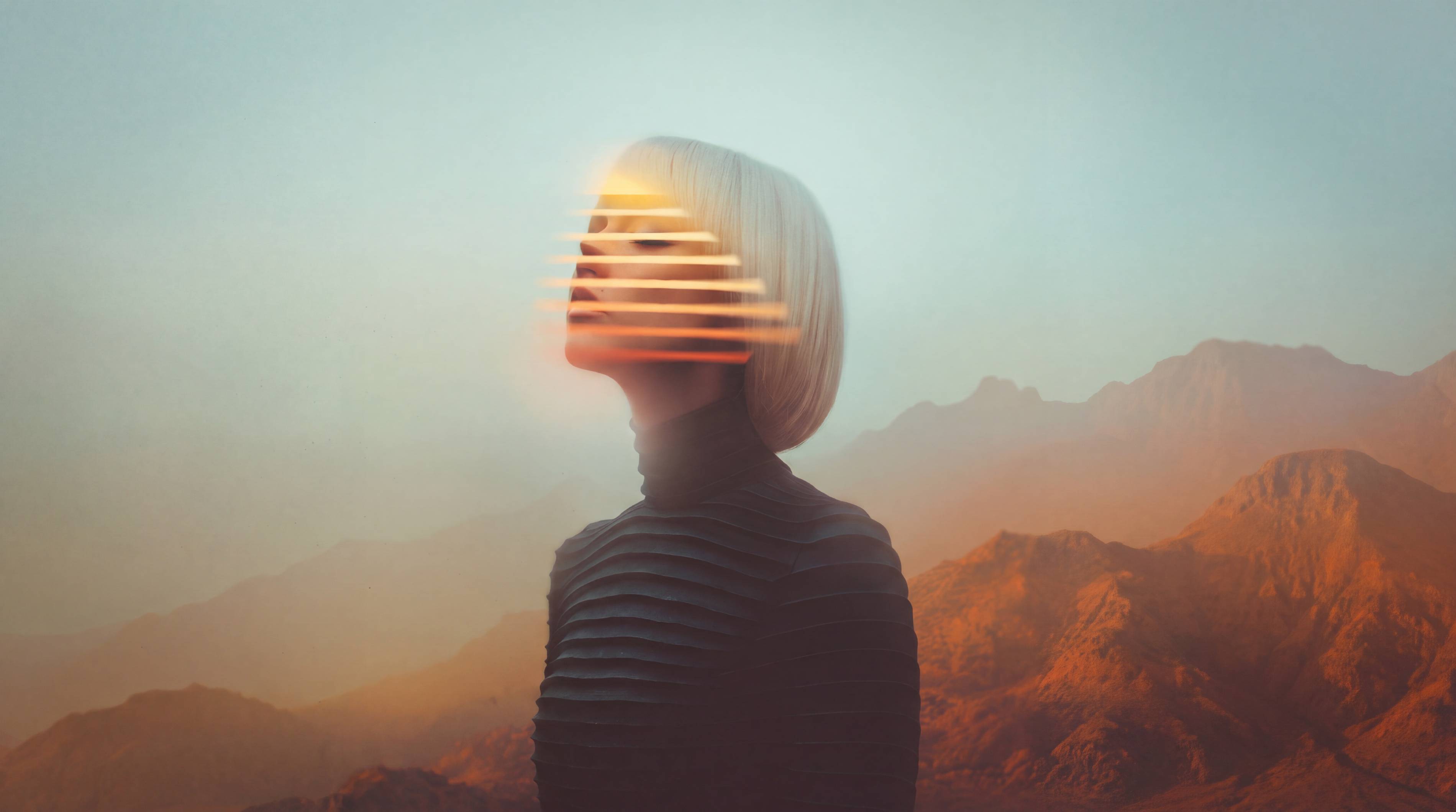 Woman in profile with glowing light streaks across her face, set against desert mountains