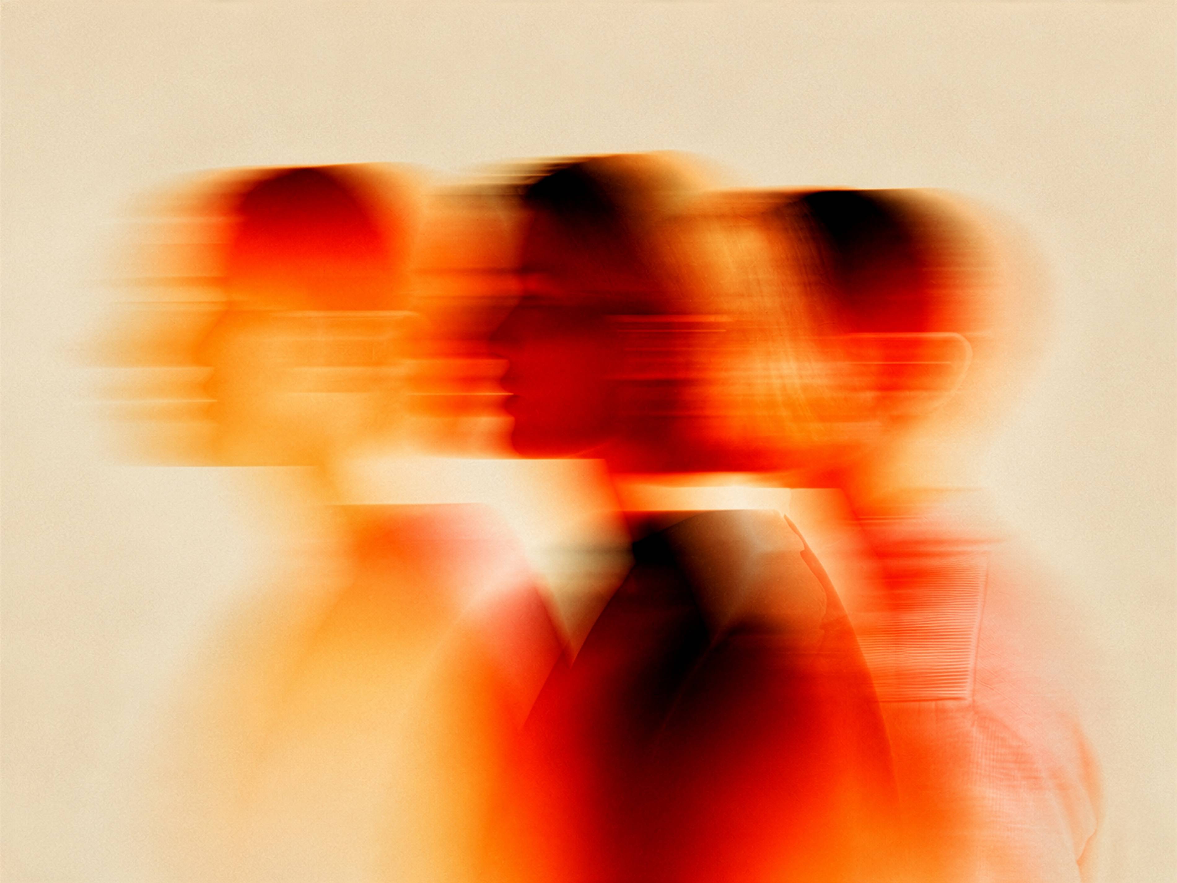 Abstract blurred red and orange profiles of people in motion