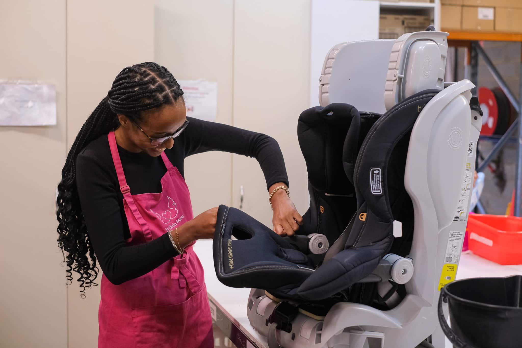 Smiling woman volunteers to clean donated goods