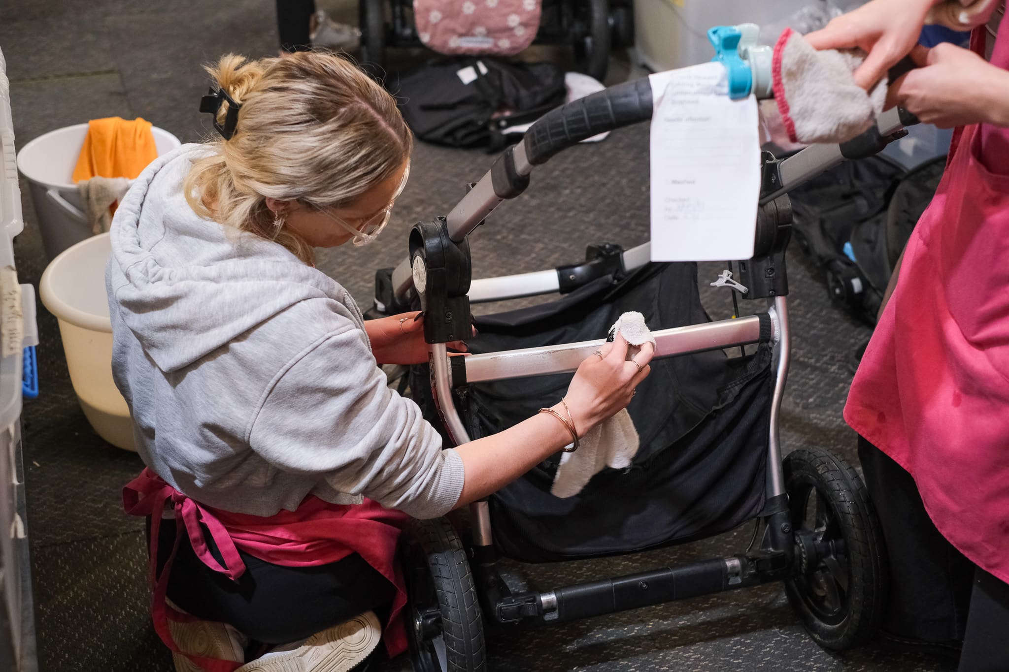 Woman volunteers to clean donated pram