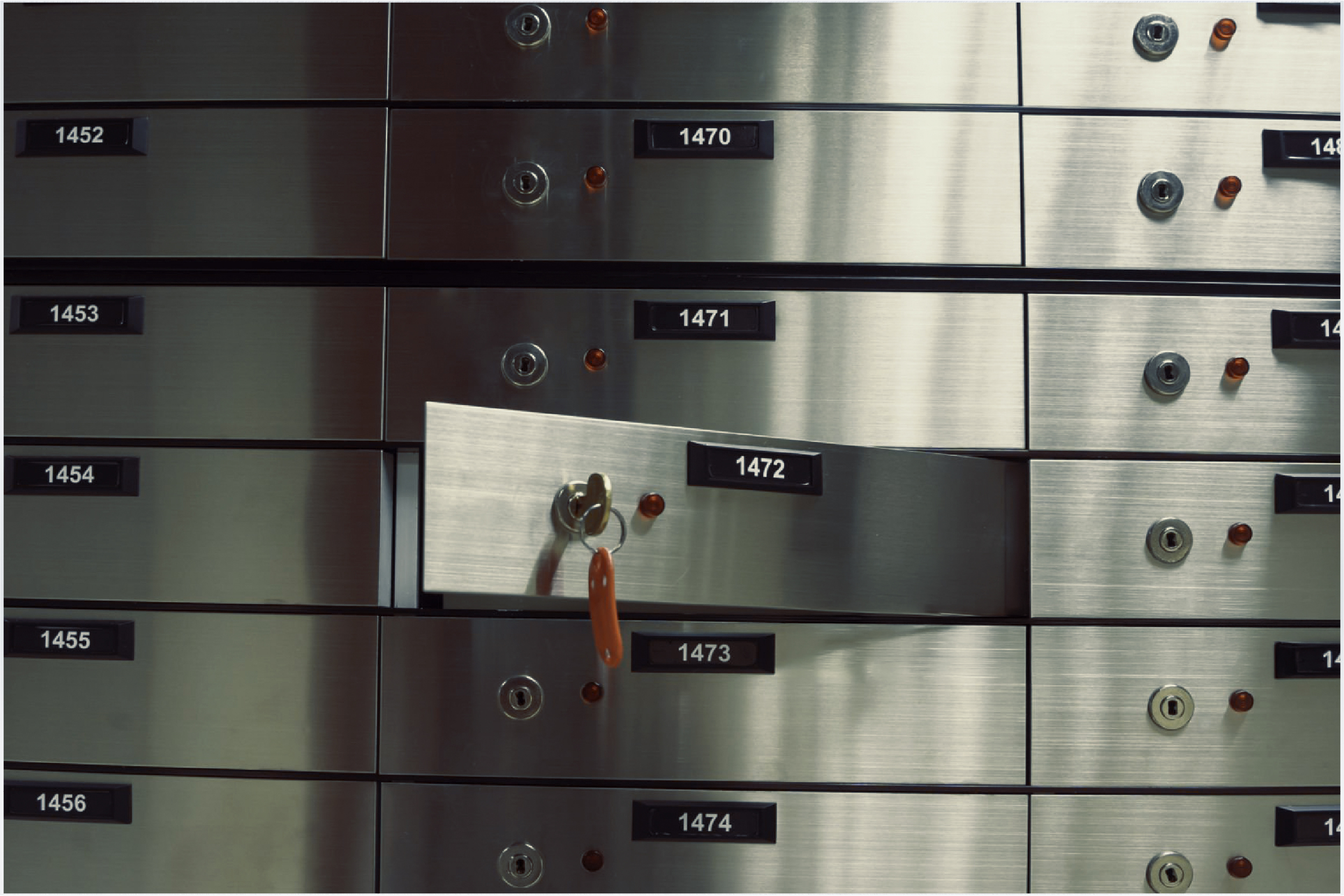Safe deposit boxes with a key in the lock.