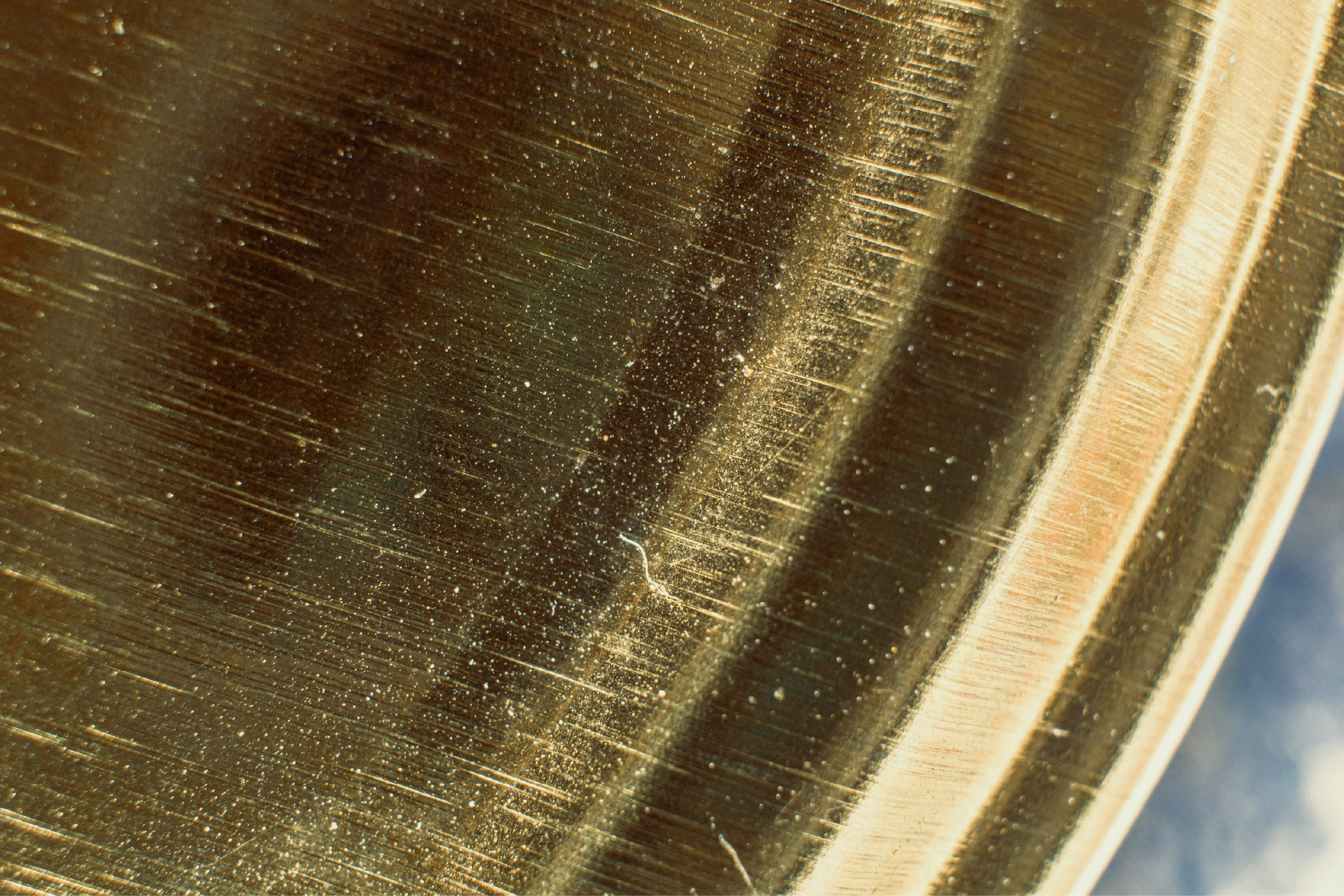Brushed brass surface of a vault fitting.