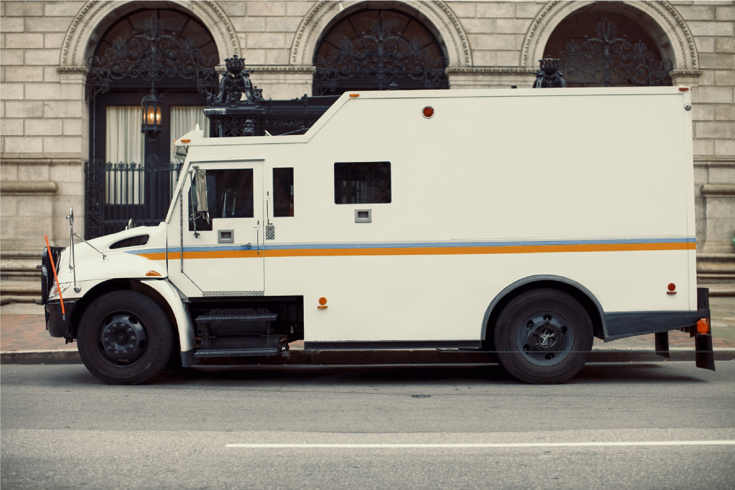 Armored transport vehicle on a city street.