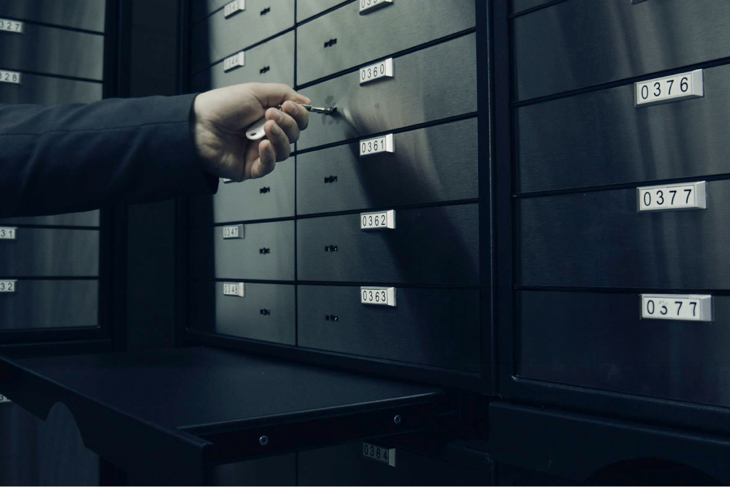 A staff member accessing a numbered safe deposit box.