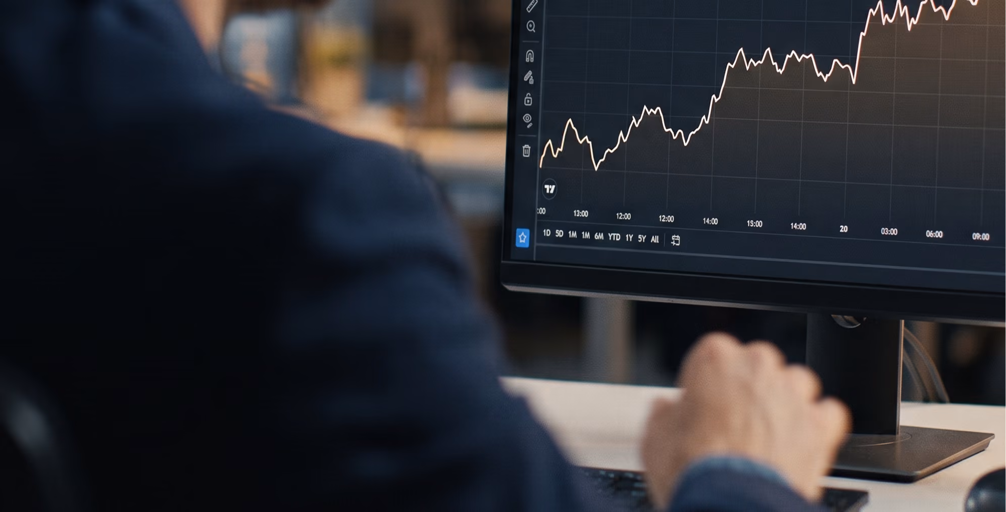 Analyst reviewing market charts on trading screens