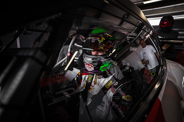 Motorsport driver preparing to race
