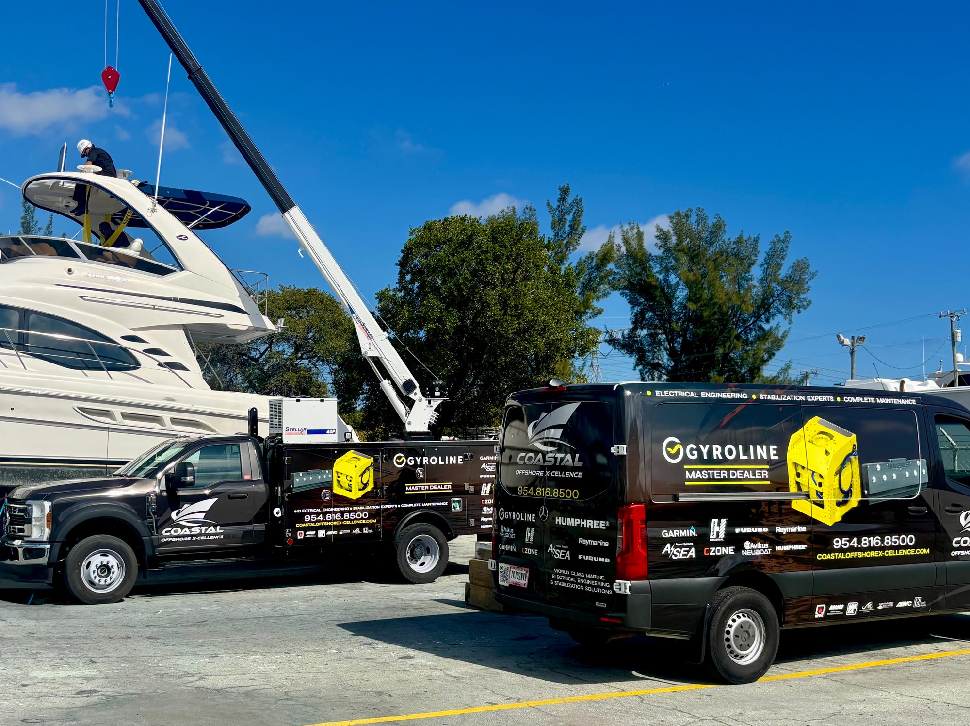 Coastal Offshore X-Cellence service vehicles beside a yacht